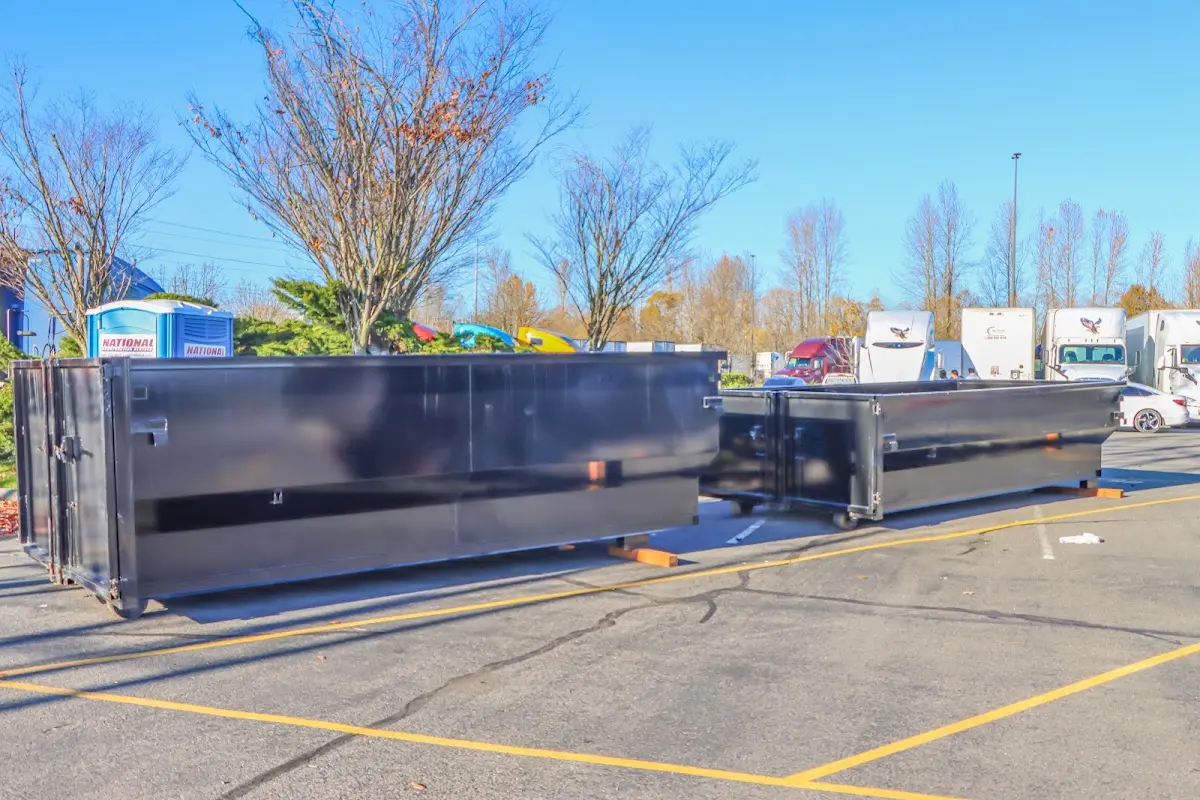 Professional dumpster rental service with roll-off container on residential driveway in Ridley Park